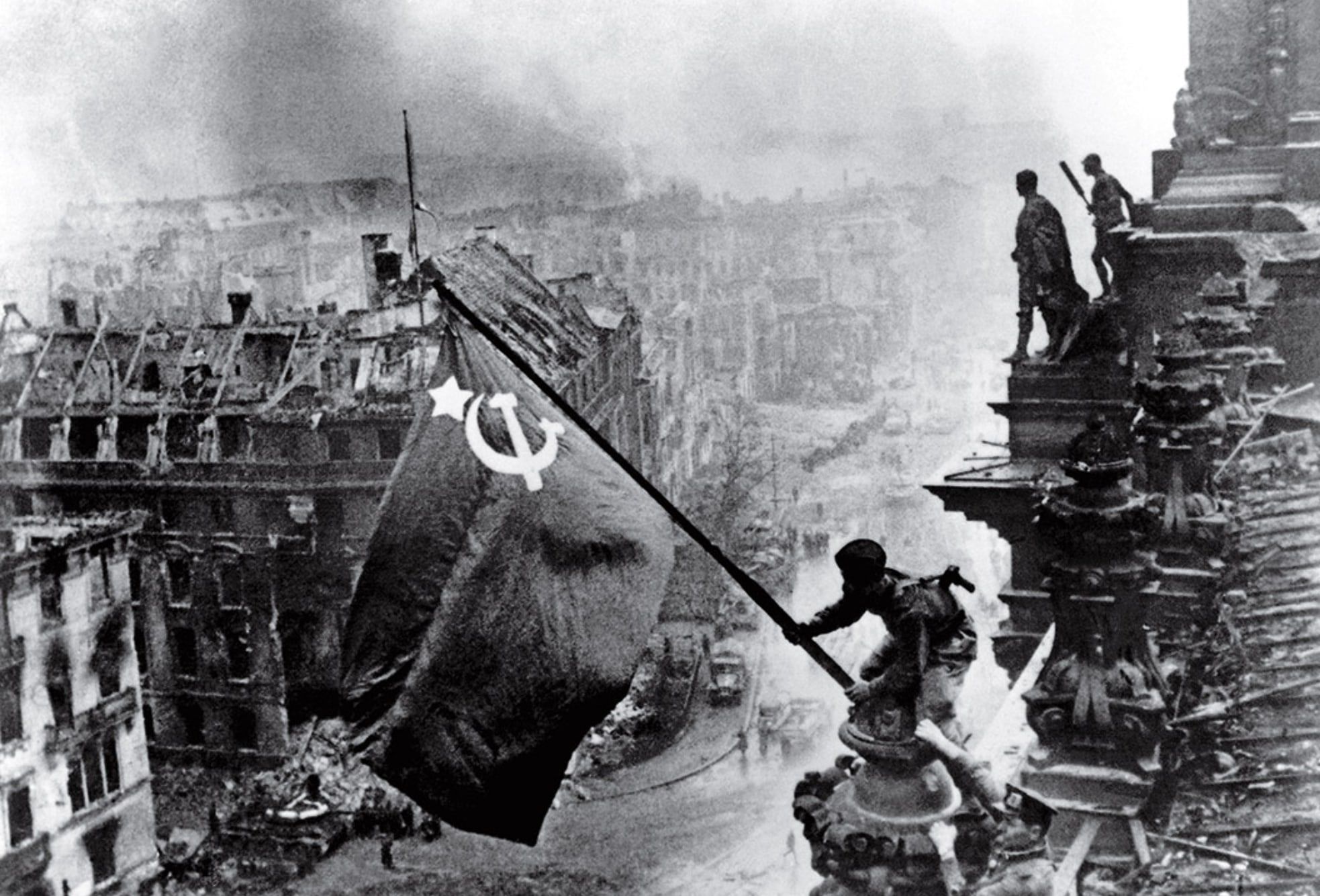Soviet soldiers raising the Red Army flag over the Reichstag, May 1945